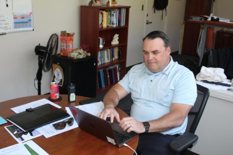 Principal Holdren at work regarding new changes and updates for next school year.