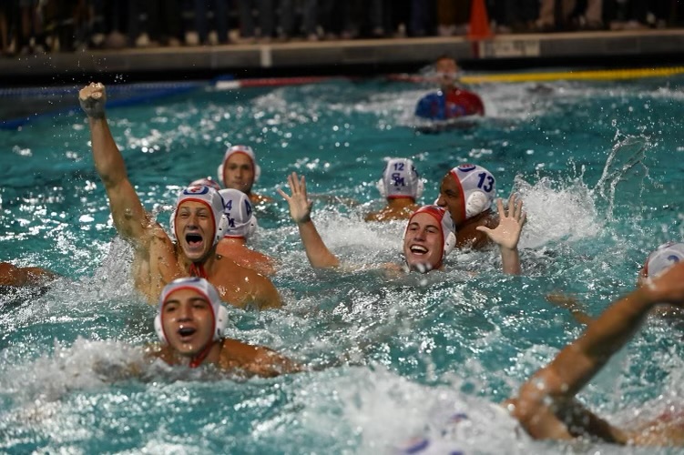 Nic Prentice, Sam Rich, and fellow San Marcos water polo players celebrate winning the CIF title after beating Dos Pueblos on Saturday.