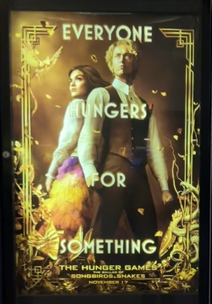Actors Rachel Zegler and Tom Blyth pose for the cover of The Hunger Games: The Ballad of Song Birds and Snakes.