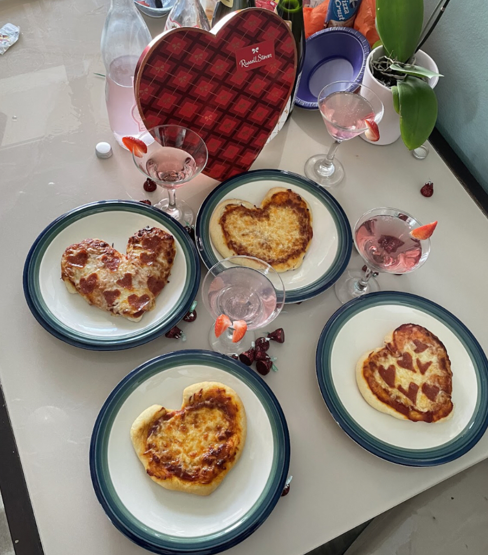 Heart shaped pepperoni slices decorate a heart shaped pizza. Gather your friends for some fun Valentine’s Day cooking.
