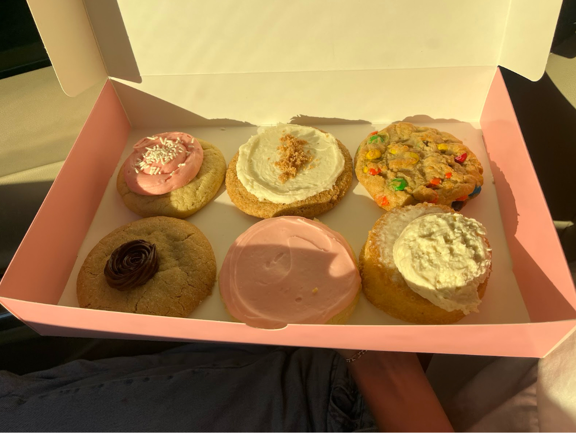 Crumbl Cookies of the Week listed from top left to bottom right: Strawberry Cupcake, New York Cheesecake, M&M, Peanut Butter Blossom, Pink Sugar, and Butter Cake 
