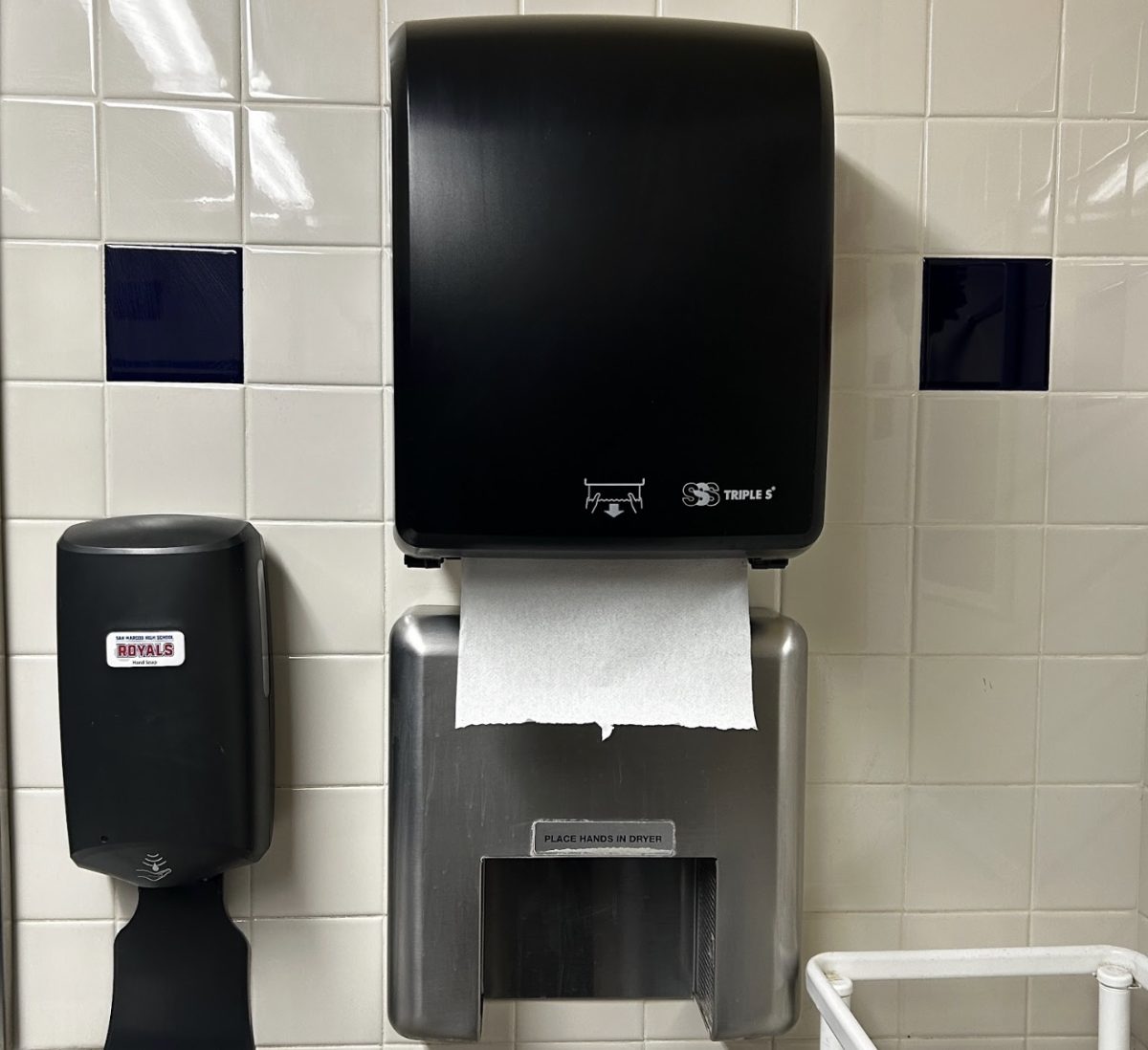 Hand dryer and paper towel dispenser located in the teacher restroom. 